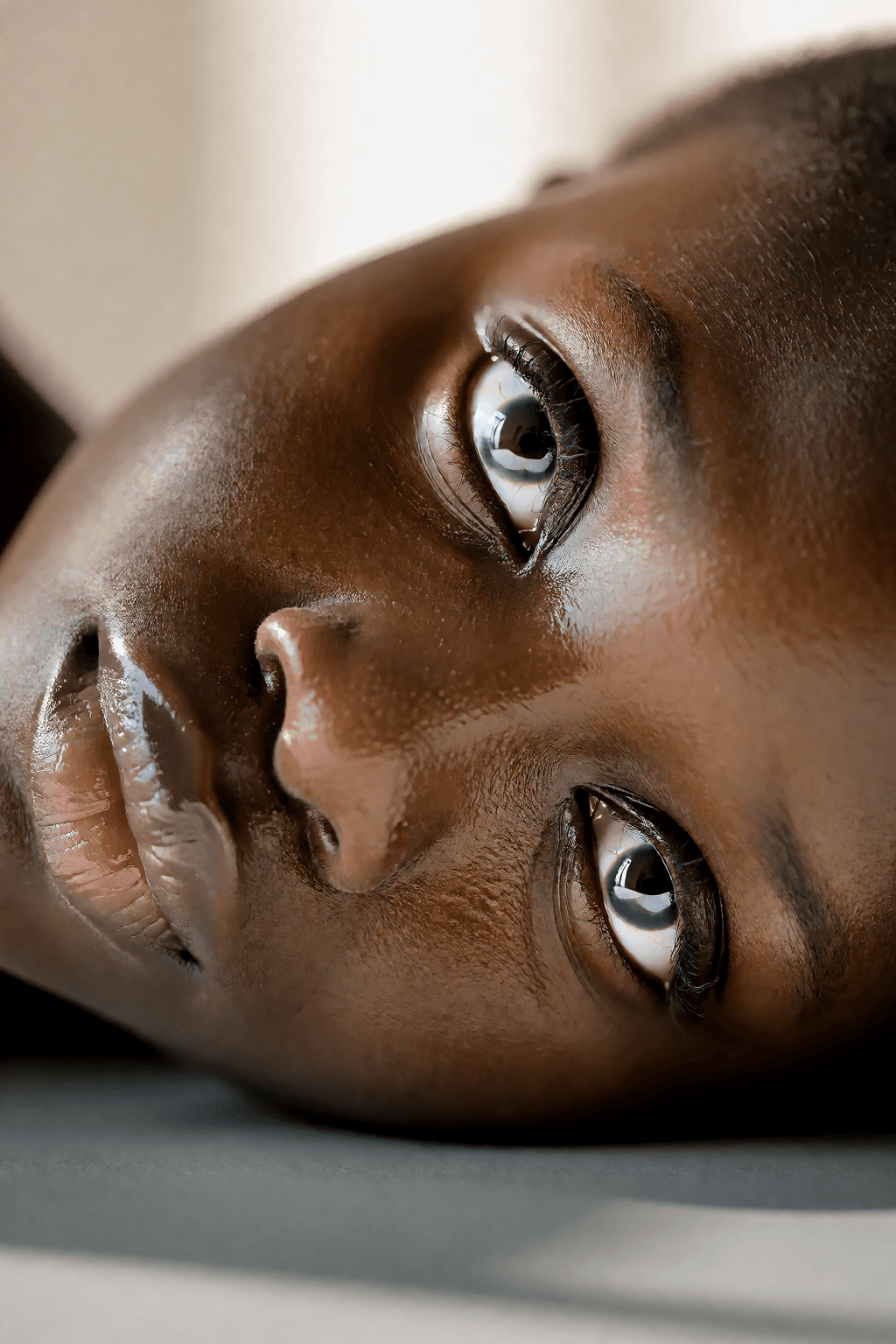 Deep skin tone: In distribution. Real sheen on the forehead and nose with pore texture still under it, not the latex look.